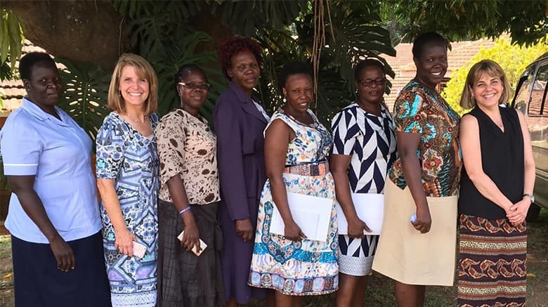 Lynn standing with women in Uganda
