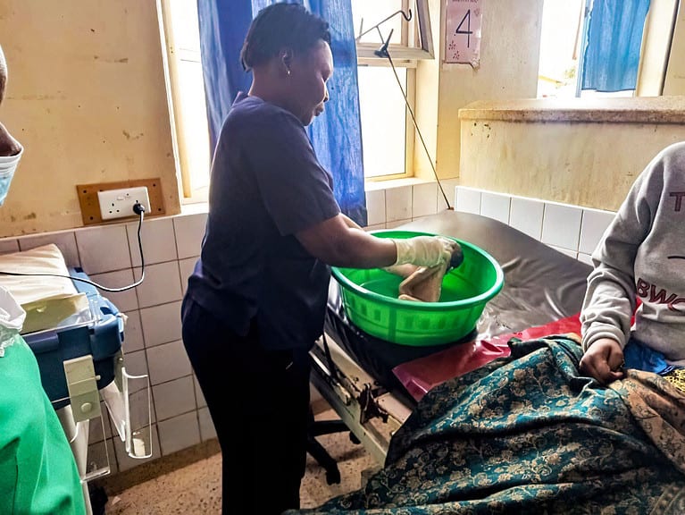 Gladys bathing a stillborn baby